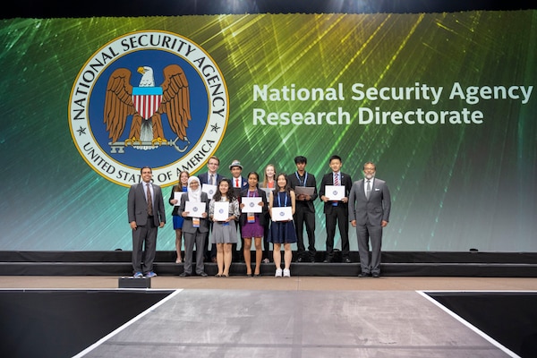 NSA ISEF 2019 Awards. Ten student award recipients stand between representatives from NSA.