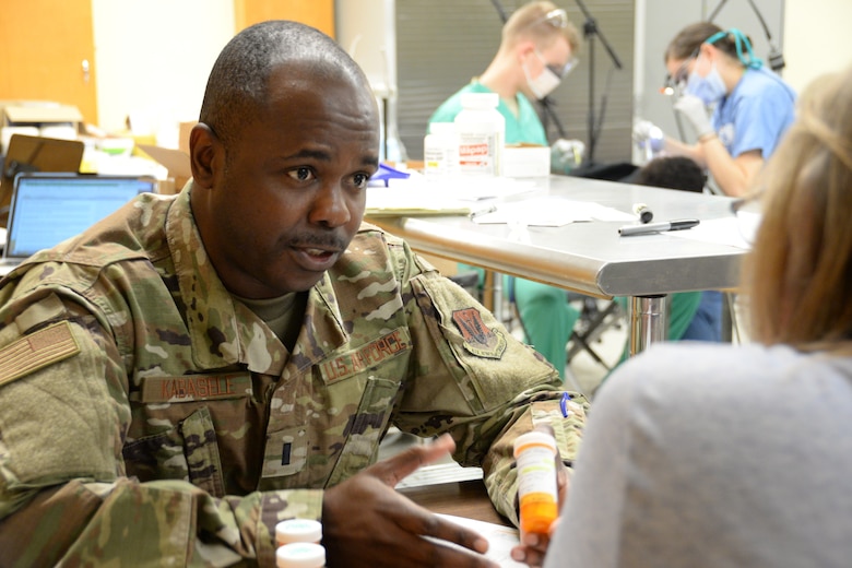 U.S. Air National Guard 1st Lt. Freddy Kabasele-Kalonji, the Cairo site pharmacy officer in charge and a critical care nurse assigned to 175th Medical Group, Baltimore, Md., speaks with a patient about proper doses for medication during an Innovative Readiness Training mission in Cairo, Ill., June 20, 2019.