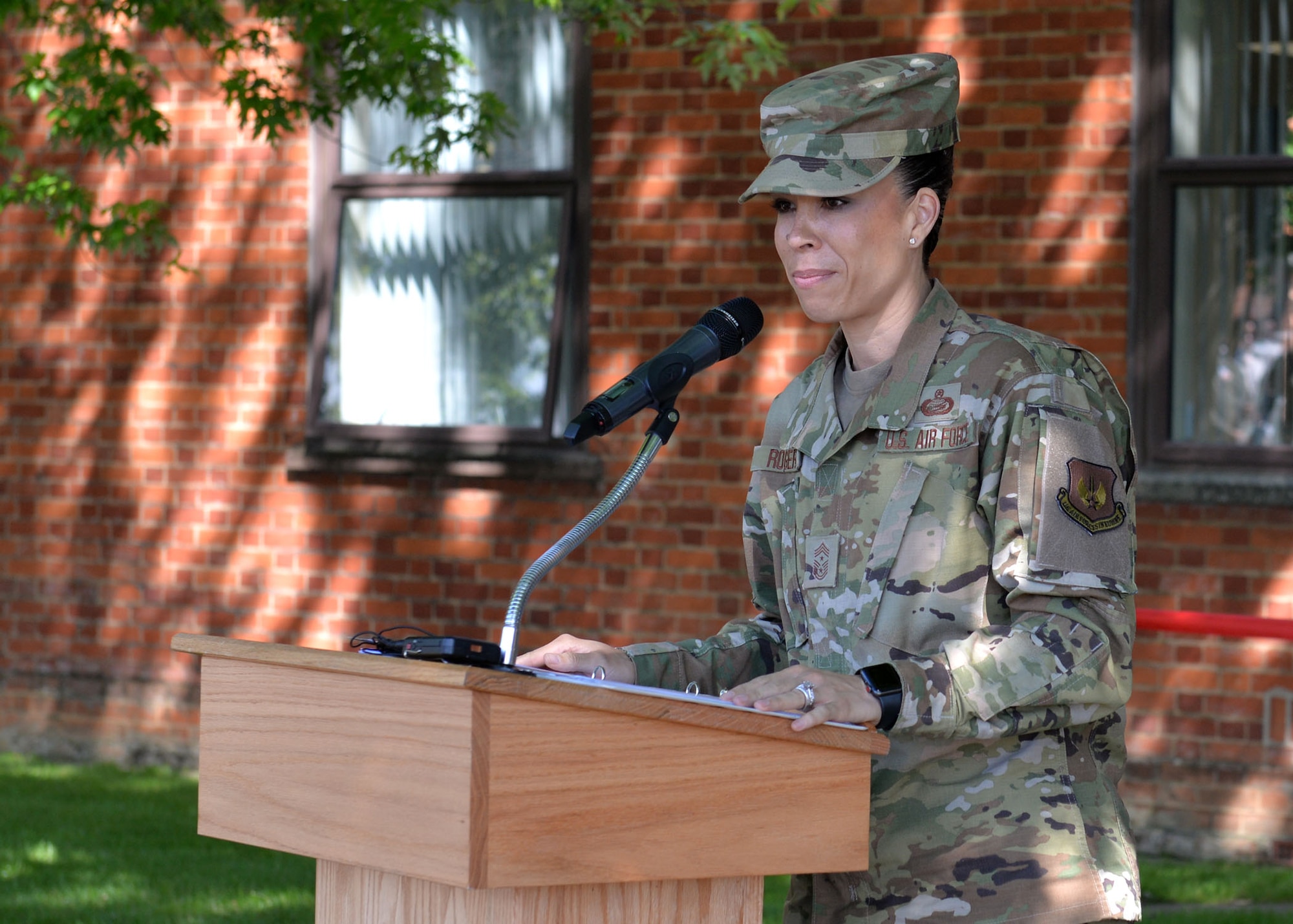 U.S, Air Force Chief Master Sgt. Kristina Rogers, 100th Air Refueling Wing command chief, gives a speech to the audience at the Professional Development Center renaming ceremony at RAF Mildenhall, England, June 21, 2019. The PDC was renamed the “Dewey R. Christopher Professional Development Center” to honor the legacy of retired Master Sgt. Dewey Christopher, a former 351st Bomb Squadron crew chief, 100th Bomb Group and World War II veteran, who was guest of honor at the event. (U.S. Air Force photo by Karen Abeyasekere)