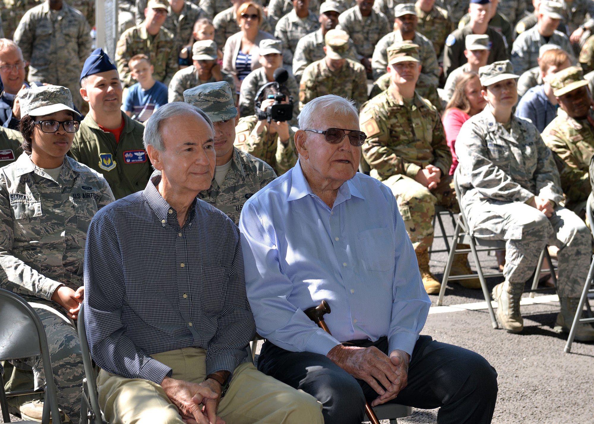 Retired Master Sgt. Dewey Christopher, a former 351st Bomb Squadron crew chief, 100th Bomb Group and World War II veteran, and his son Gary, listen to a speech from Chief Master Sgt. Kristina Rogers, 100th Air Refueling Wing command chief, at the renaming ceremony of the Professional Development Center at RAF Mildenhall, England, June 21, 2019. The PDC was renamed the “Dewey R. Christopher Professional Development Center” to honor his legacy and enhance heritage for enlisted members. (U.S. Air Force photo by Karen Abeyasekere)