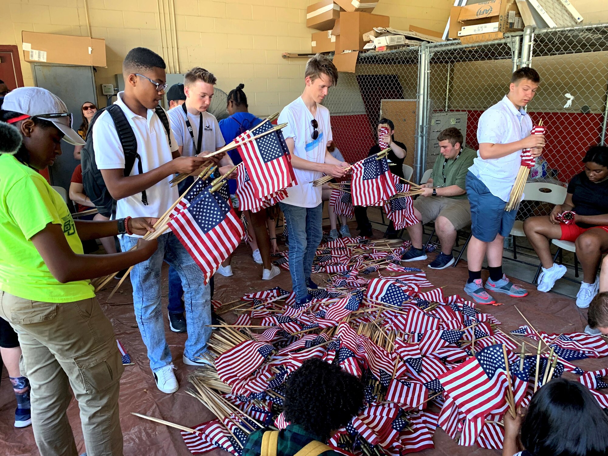 Attendees of the 2019 Youth of the Year Summit gather, roll and store American flags at the Fort Sam Houston Cemetery June 19. During their week in Texas, about 60 teens from across the Air Force took part in a variety of activities focused on teambuilding, leadership, community service and personal growth. The Air Force, through the Air Force Services Center, partners with the Boys and Girls Clubs of America to offer the Youth of the Year program.
