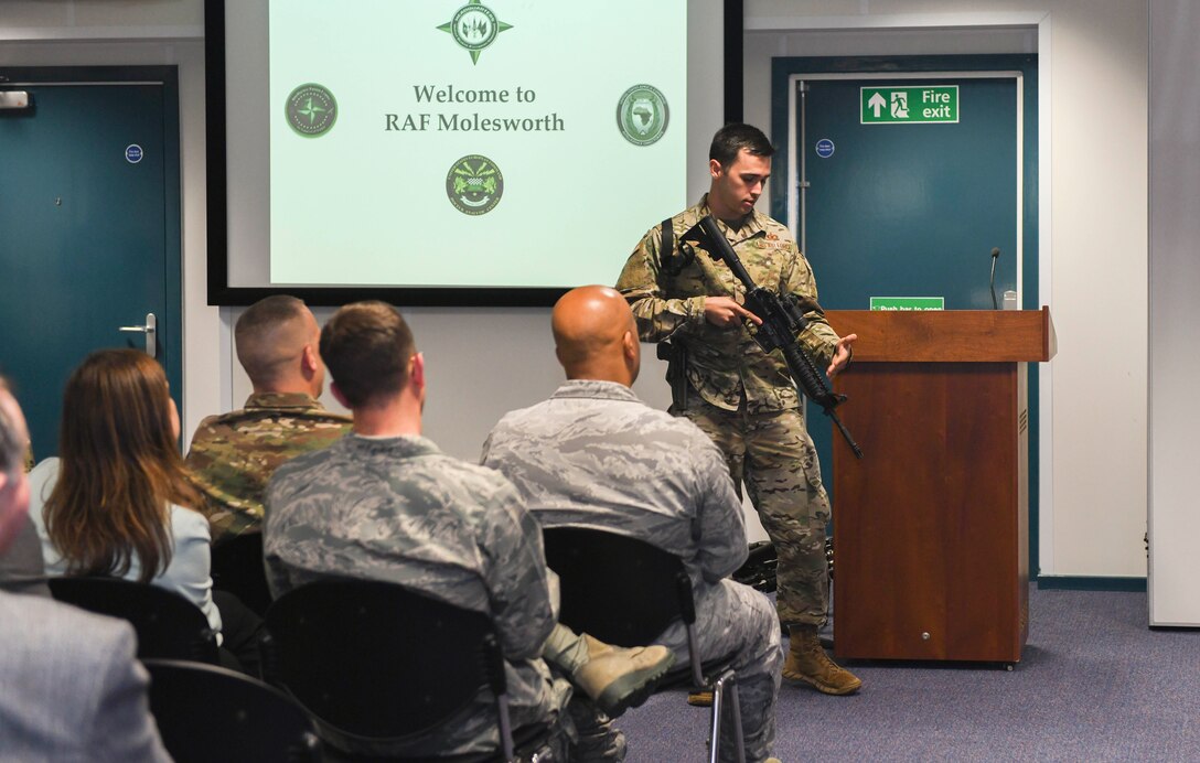 U.S. Air Force Staff Sgt. George Henry lll, 423rd Security Forces Squadron combat arms instructor, showcases various weapon systems to civic leaders at RAF Molesworth, June 26, 2019. The civic leaders came to the base for an opportunity to meet senior leadership, gain an understanding of the 501st Combat Support Wing's mission and contributions made by the U.S. to the local community. (U.S. Air Force photo by Senior Airman Chase Sousa)