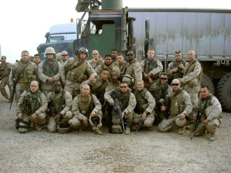 Vehicle Operator and Squad Leader poses with the 3rd Platoon, Combat Logistics Regiment 25, following a resupply convoy in 2005, in northern Iraq.