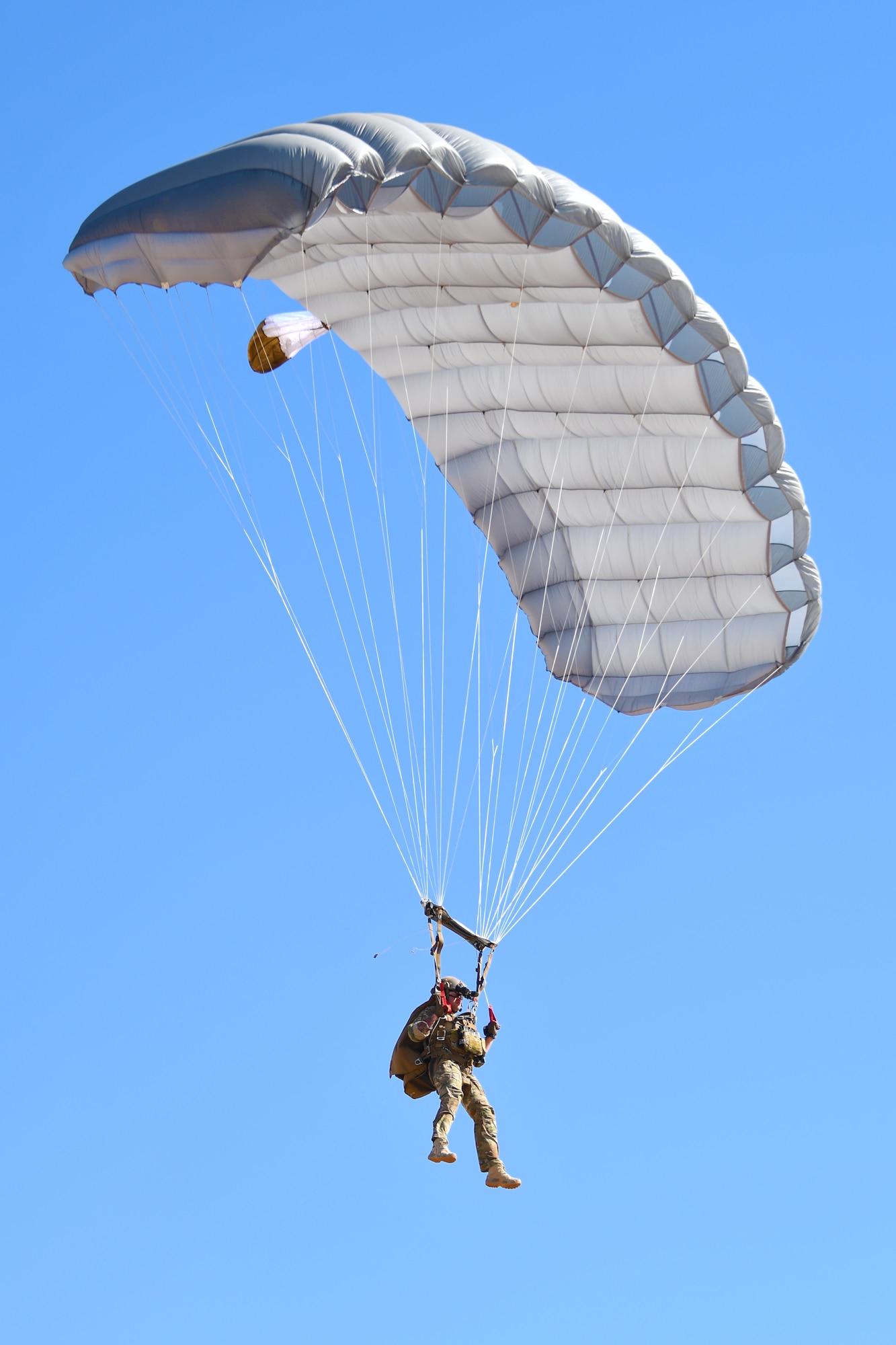 A U.S. Air Force pararescueman accomplishing five-level upgrade training parachutes into a drop zone at the Marana Regional Airport, Ariz., June 26, 2019.