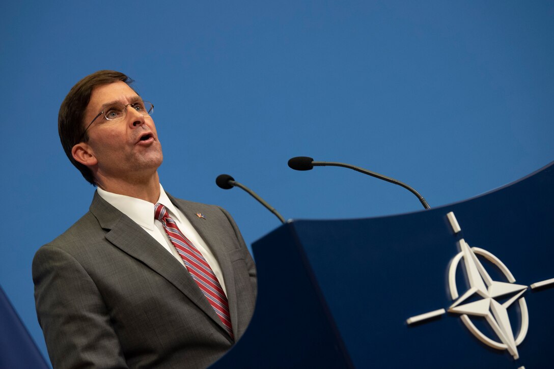 A man gives a speech at a podium.