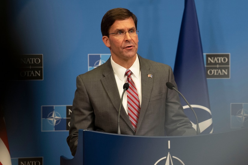 A man gives a speech at a podium.