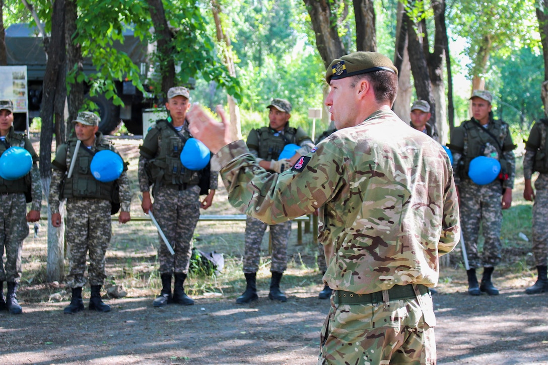 A British Army soldier instructs Kazakhstani soldiers how to respond to a crowd control situation, June 20, 2019, during the field academics phase of Steppe Eagle 19. During the exercise, the British Army taught the Kazakhstanis, Tajikistanis, the U.S., and Kyrgyzstanis how to maintain public order or respond to escalating tensions. Steppe Eagle 19 is an annual U.S. Army Central-led exercise that promotes regional stability and interoperability in the Central and South Asia region.(U.S. Army photo by Maj. Kevin Sandell)