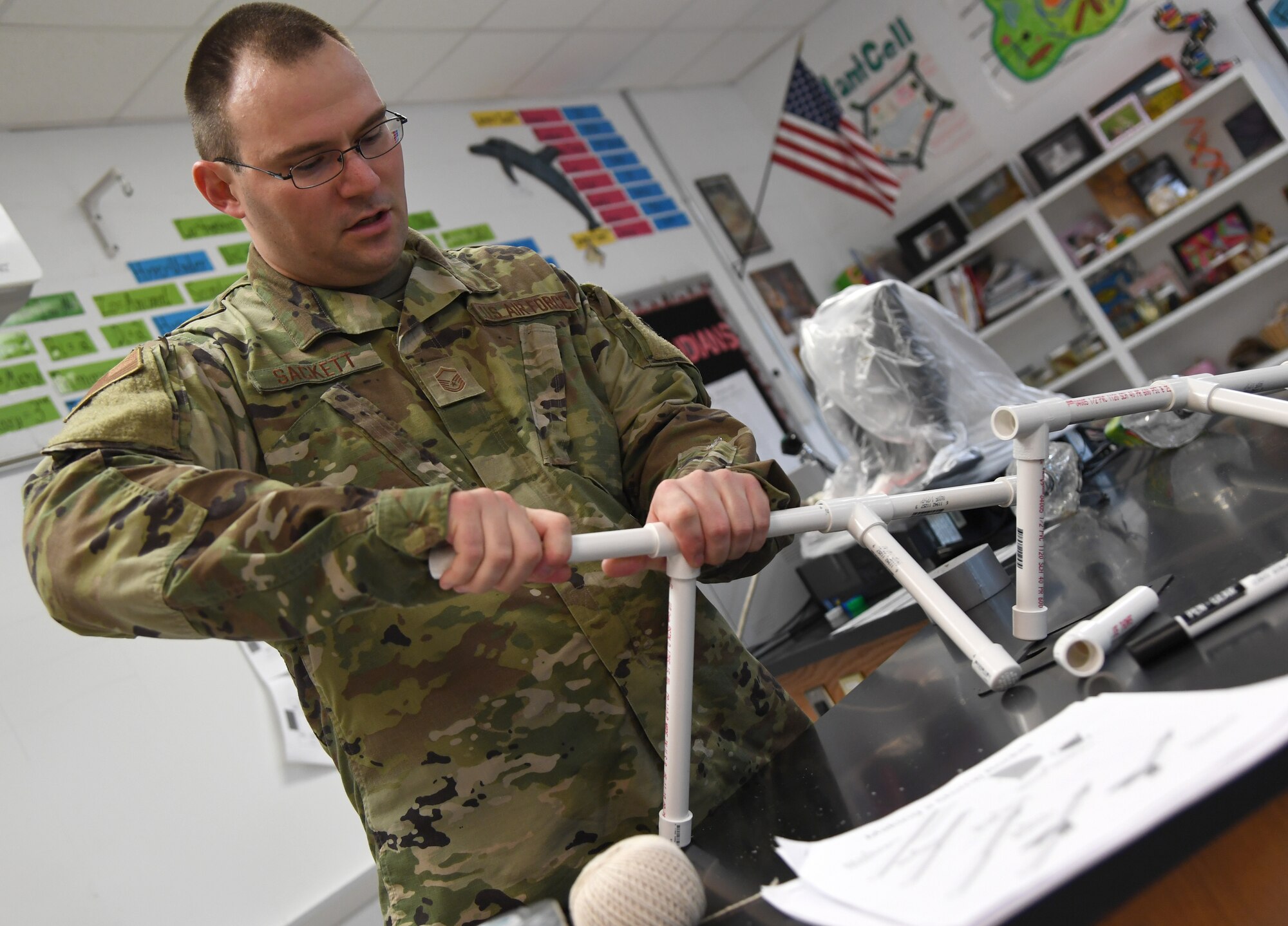 U.S. Air Force Master Sgt. Dell-Ray Sackett, 338th Training Squadron assistant flight chief, assembles a pvc pipe base for a jet propulsion laboratory stomp rocket experiment during the Biloxi Public Schools Science, Technology, Engineering and Mathematics Summer Camp program at Biloxi High School in Biloxi, Mississippi, June 25, 2019. The four-day STEM summer program teaches first through seventh grade students skills for future careers and fosters valuable life skills like problem solving, creativity and collaboration. Keesler personnel volunteered their time to lead instructions on various projects. (U.S. Air Force photo by Kemberly Groue)