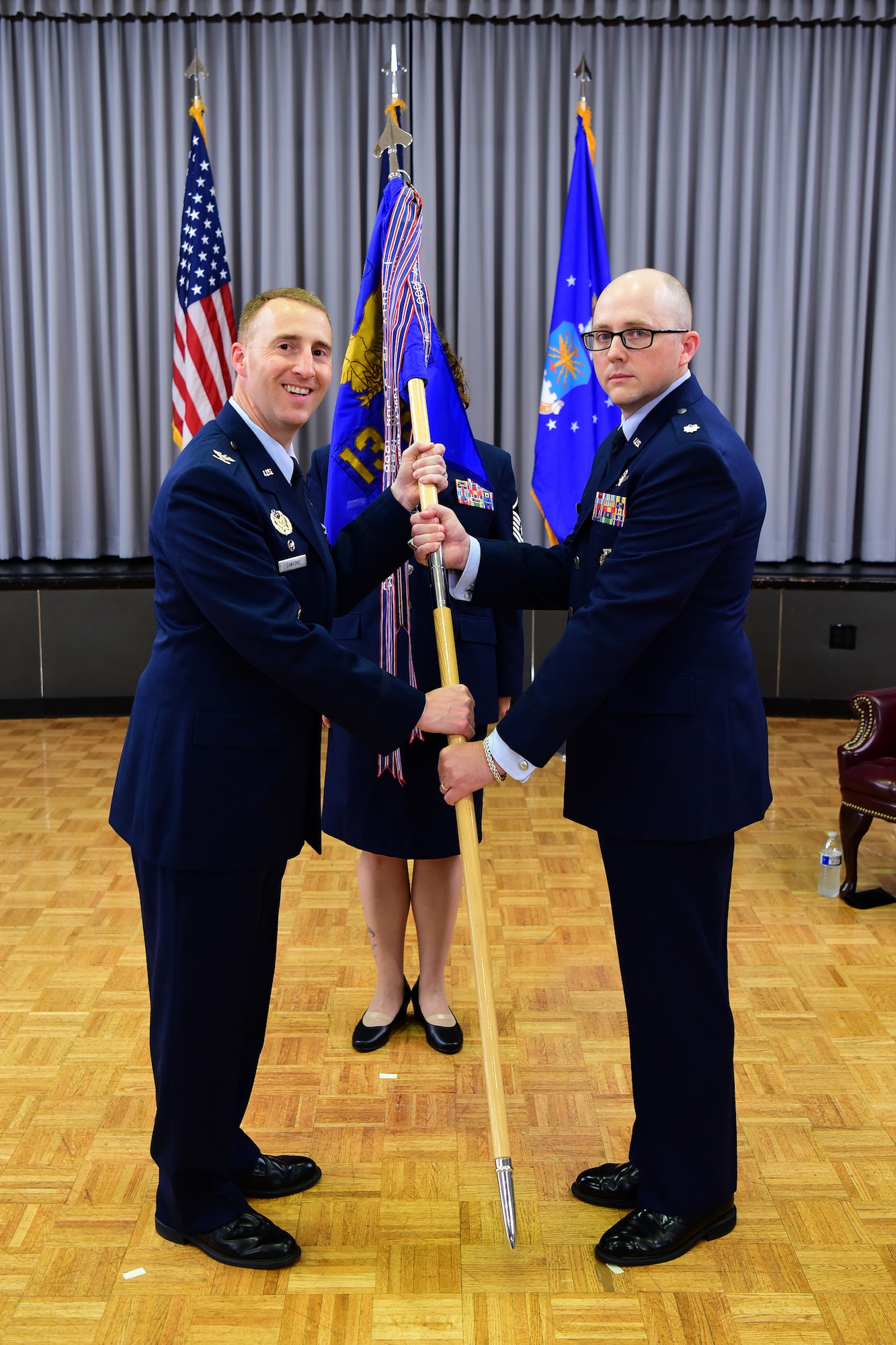 CLEAR AIR FORCE STATION, Alaska--Col. Matthew Cantore (left), 21st Operations Group commander, passes the unit guidon to Lt. Col. Shawn Lee, during the 13th Space Warning Squadron change of command ceremony at Clear Air Force Station, Alaska, June 20, 2019. Lee assumed command of the interior Alaska unit, replacing Lt. Col. Jeffrey Rutherford, who has completed his tour of duty in Alaska and will be assigned to the 21st OG, Peterson Air Force Base, Colorado. (U.S. Air National Guard photo by Senior Master Sgt. Paul Mann)