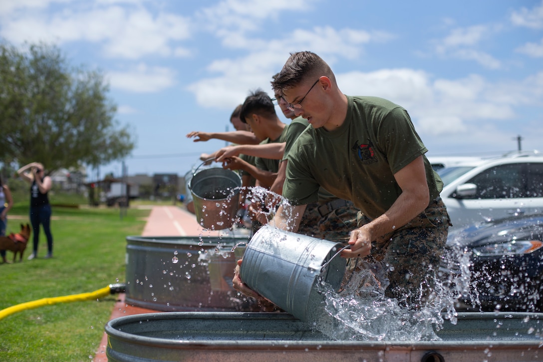 Marines with the Yuma Aircraft Rescue and Firefighting (ARFF) conduct a water transfer challenge at Marine Corps Air Station Miramar, Calif., June 22. The ARFF rodeo is an annual event held by H&HS to build unit cohesion and boost morale through various competitions between different ARFF units. (U.S. Marine Corps photo by Lance Cpl. Cheng Chang)