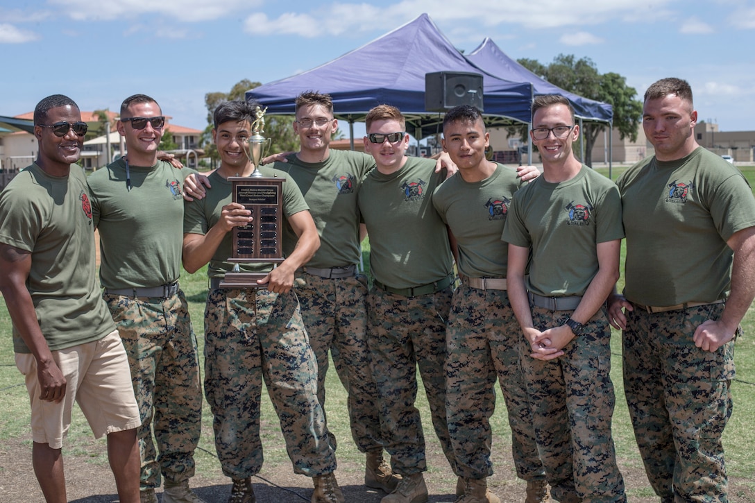 Marines with Yuma Aircraft Rescue and Firefighting (ARFF) pose for a winning shot with their trophy from the ARFF Rodeo competition at Marine Corps Air Station Miramar, Calif., June 22. The ARFF rodeo is an annual event held by H&HS to build unit cohesion and boost morale through various competitions between different ARFF units. (U.S. Marine Corps photo by Lance Cpl. Cheng Chang)
