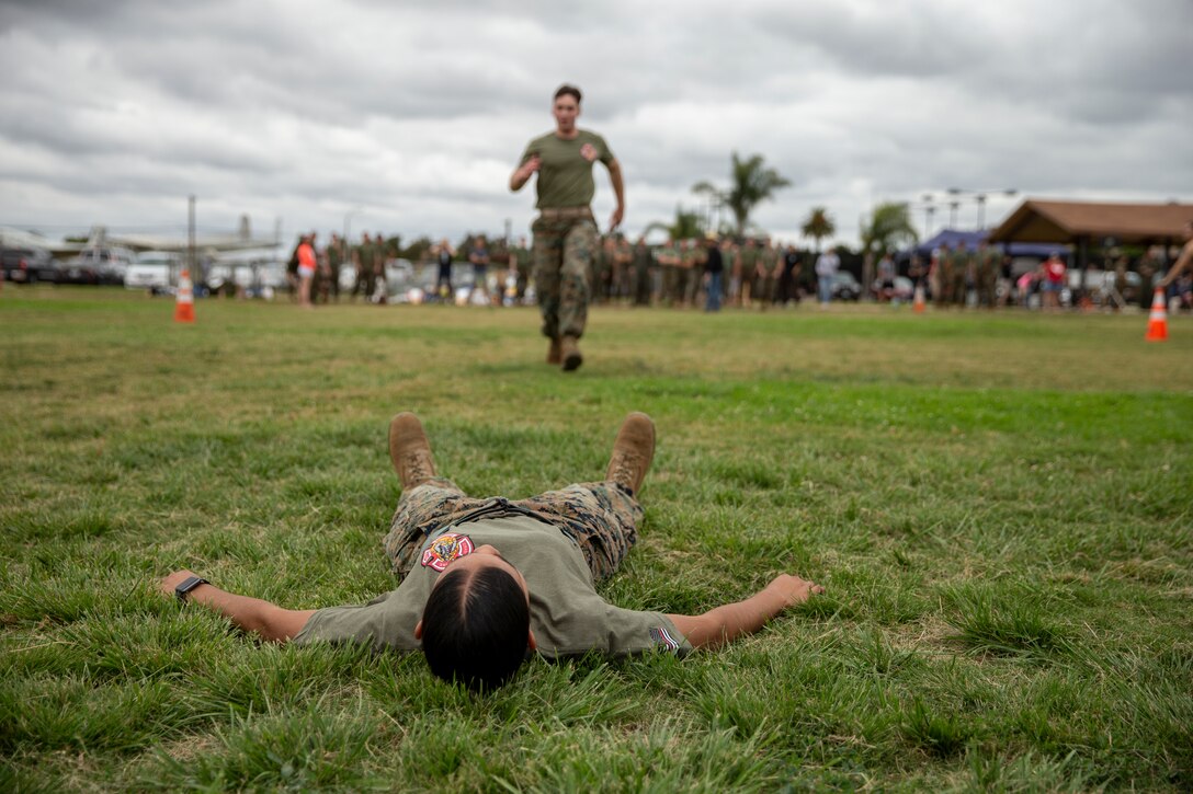 Lance Cpl. Stephanie Reina-Mata with Aircraft Rescue and Firefighting (ARFF) waits for her fellow marine to conduct a fireman carry at Marine Corps Air Station, Calif., June 22. The ARFF rodeo is an annual event held by H&HS to build unit cohesion and boost morale through various competitions between different ARFF units. (U.S. Marine Corps photo by Lance Cpl. Cheng Chang)