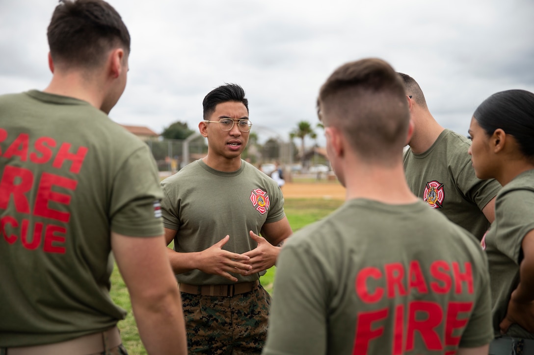 Sgt. John A. Reyes, a lead firefighter with Miramar Aircraft Rescue and Firefighting (ARFF) coaches his team for the upcoming ARFF rodeo relay competition at Marine Corps Air Station, Calif., June 22. The ARFF rodeo is an annual event held by H&HS to build unit cohesion and boost morale through various competitions between different ARFF units. (U.S. Marine Corps photo by Lance Cpl. Cheng Chang)