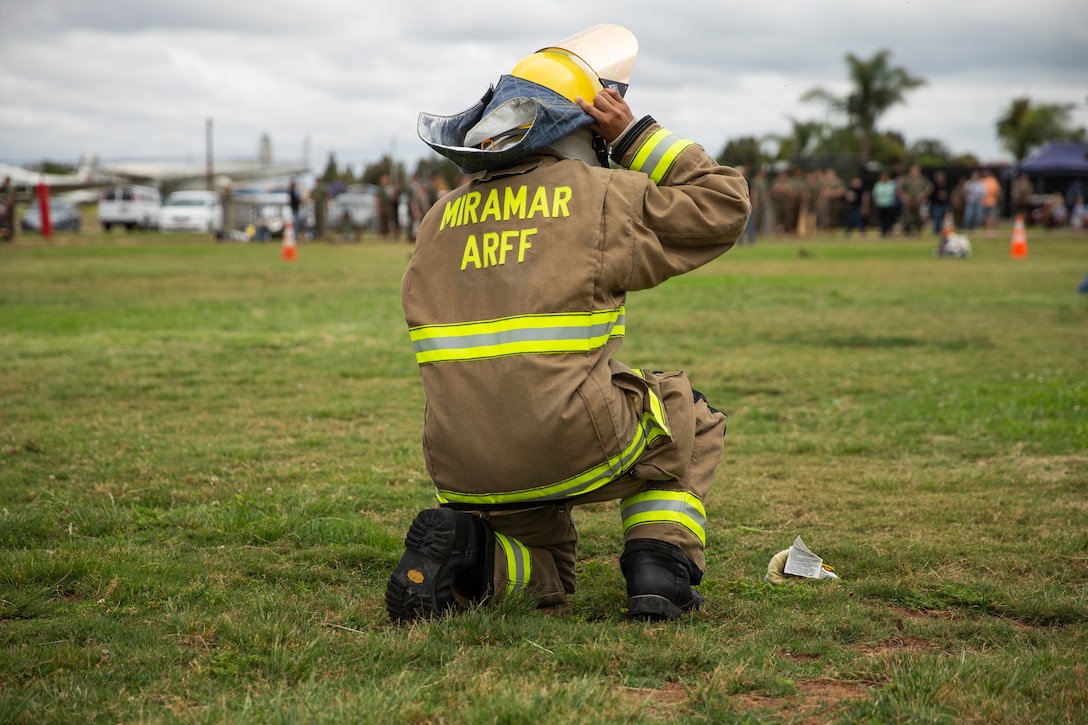 Lance Cpl. Stephanie Reina-Mata, a marine with Miramar Aircraft Rescue and Firefighting (ARFF), puts on her gear in her part of the ARFF rodeo relay competition at Marine Corps Air Station Miramar, Calif., June 22. The ARFF rodeo is an annual event held by H&HS to build unit cohesion and boost morale through various competitions between different ARFF units. (U.S. Marine Corps photo by Lance Cpl. Cheng Chang)