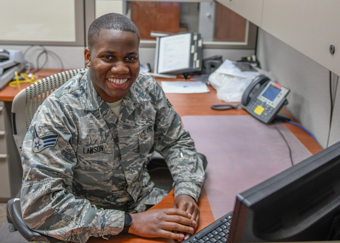 Senior Airman Robert Lawson, a knowledge operations specialist with the 910th Communications Squadron here, poses for a photo at his desk on May 14, 2019.
