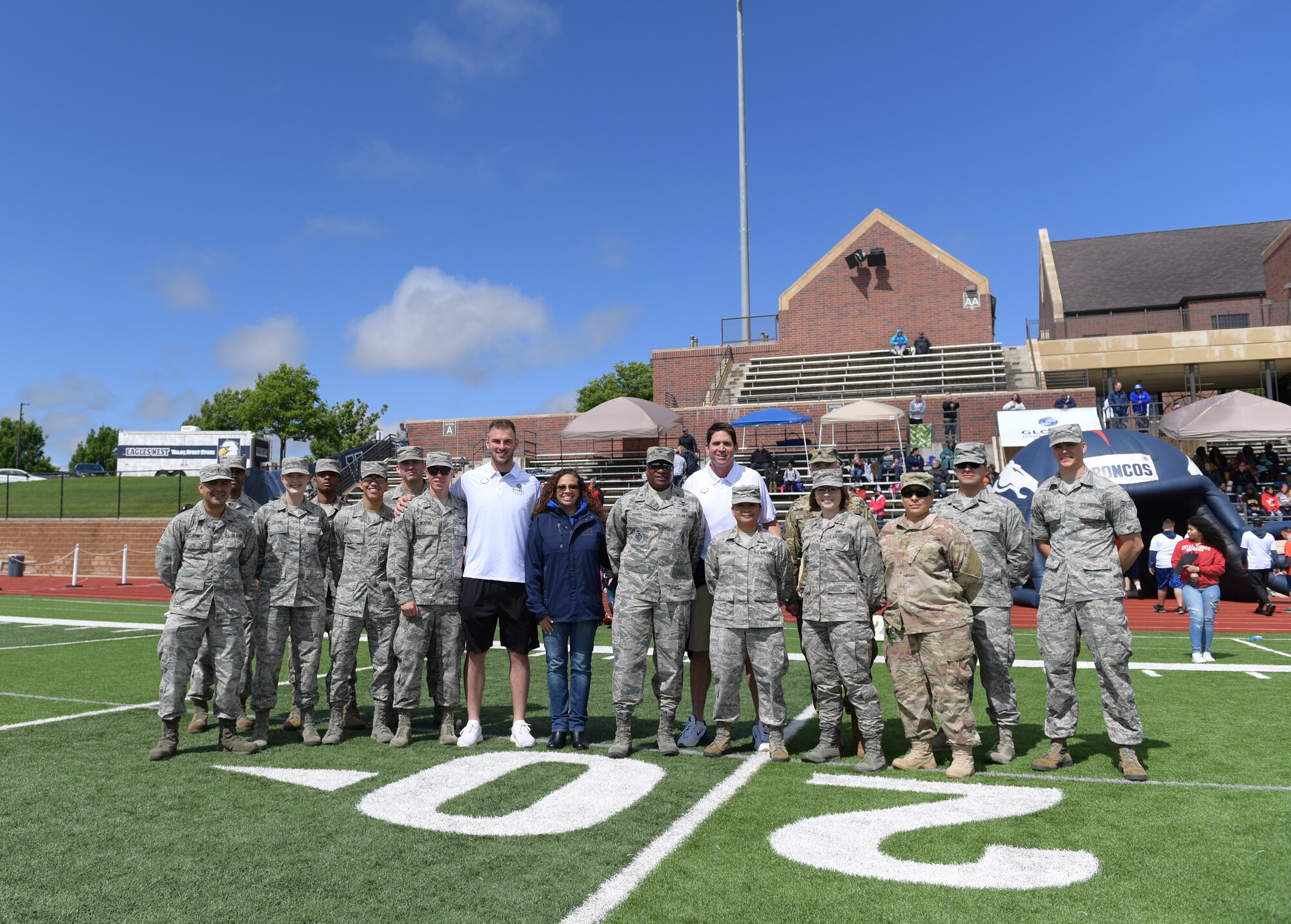 Members of Team Buckley pose for a group photo with National Football League players following the 10th annual Dare to Play football event June 22, 2019, in Highlands Ranch, Colorado.