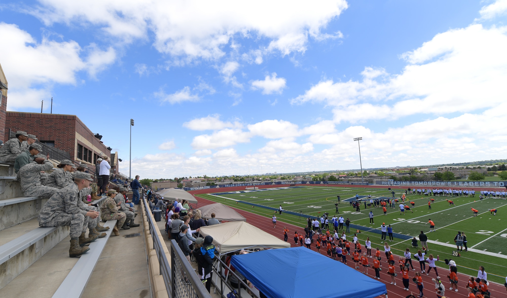 Members of Team Buckley watch the 10th annual Dare to Play football game June 22, 2019, in Highlands Ranch, Colorado.