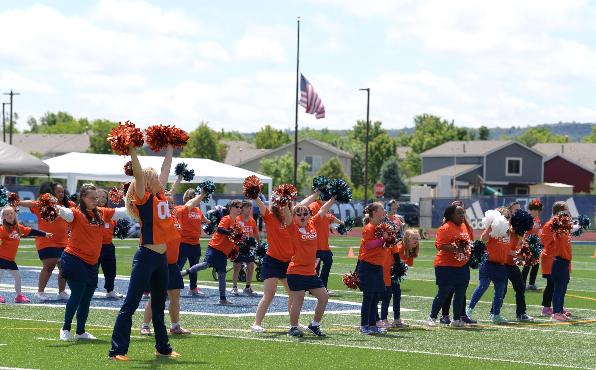 Cheerleaders with the Denver Broncos lead the cheerleaders for the Dare to Play football event during the half time show June 22, 2019, in Highlands Ranch, Colorado.