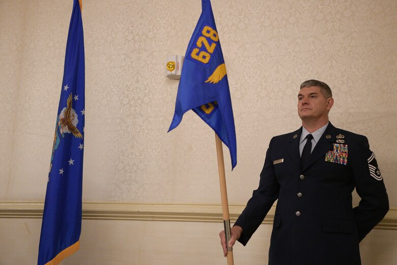 Senior Master Sgt. Adam Car, 628th Comptroller Squadron superintendent, holds the 628th CPTS guidon during a change of command ceremony June 27, 2019, at Joint Base Charleston, S.C. The squadron bid farewell to Lt. Col. Bryan Collins, the outgoing commander, and welcomed Maj. Jahayra N. Lowe as the new squadron commander. The passing of the guidon is a ceremonious representation of an incoming commander's assumption of command. The change of command ceremony acts as a formal transfer of responsibility, authority and accountability from the outgoing to incoming commander