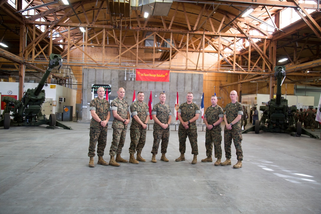 Colonel Craig Clemans, base commanding officer, Col. Eric Livingston, commanding officer of Marine Depot Maintenance Command, Sgt. Maj. Michael Rowan, Logistics Command sergeant major, Maj. Gen. Joseph Shrader, commanding general Marine Corps Logistics Command, Col. Kipp Wahlgren, commanding officer of Marine Force Storage Command, Lt. Col. Micheal Graham, 1st Force Storage Battalion commanding officer, Col. Daniel Coleman, assistant chief of staff G-3 Logistics Command, pose for a portrait after the activation ceremony for 1st Force Storage Battalion on the Yermo Annex aboard Marine Corps Logistics Base Barstow, Calif., June 26. The 1st FSB offers a full range of maintenance, repair, storage and more for Marine Corps equipment, providing crucial support for the overall Corps mission.
