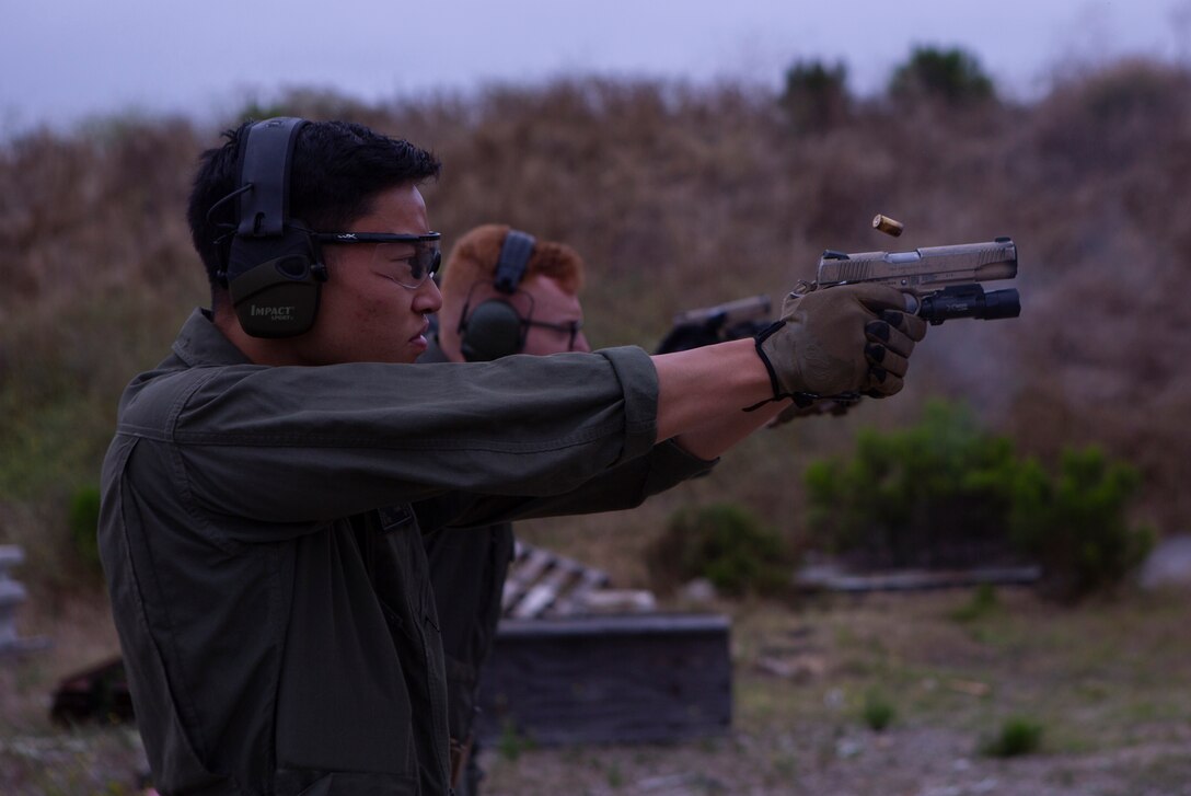 Cpl. Jeremy Chow, a Marine Corps Air Station Miramar Special Reactions Team (SRT) member, fires the M45A1 Service Pistol during training at MCAS Miramar, Calif., June 26. The Marines conducted this training to improve their ability to perform in close quarter combat. (U.S. Marine Corps photo by Lance Cpl. Raynaldo Ramos)