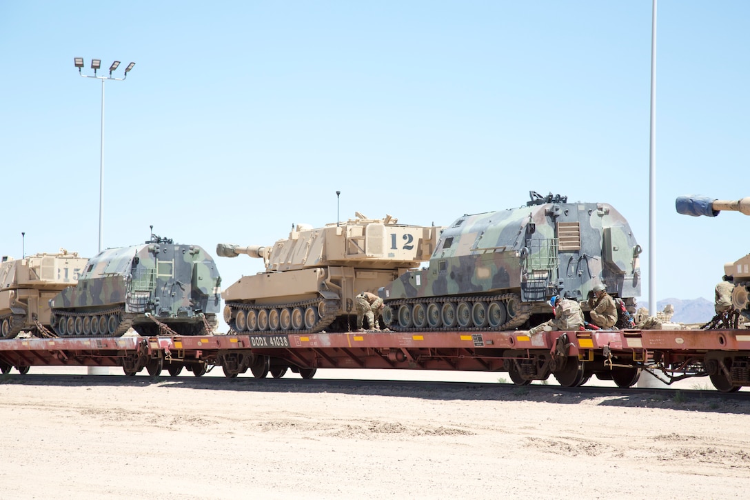 Soldiers with the Idaho National Guard upload tracked equipment such as the M60 AVLB, the M-109 and the M0992 onto railcars for transportation during training exercises, as part of their mission aboard Marine Corps Logistics Base Barstow, Calif., June 21.