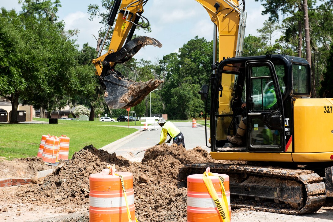 Construction workers transport dirt for a cement mold during a storm-drain construction project, June 25, 2019, at Moody Air Force Base, Ga. The 23d Civil Engineer Squadron spent $41,000 to improve the drainage system to prevent safety hazards caused by standing water. (U.S. Air Force photo by Senior Airman Erick Requadt)