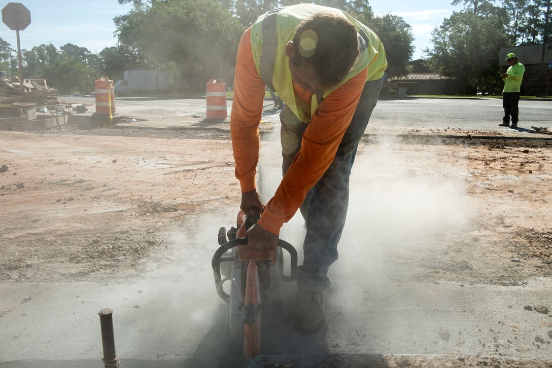 Alex Rondon, construction worker, applies joints to concrete during a storm-drain construction project, June 26, 2019, at Moody Air Force Base, Ga. The construction will rebuild three curb-inlets and reinforce storm-drain piping to improve the draining system and allow rain water to flow into a local creek. (U.S. Air Force photo by Senior Airman Erick Requadt)