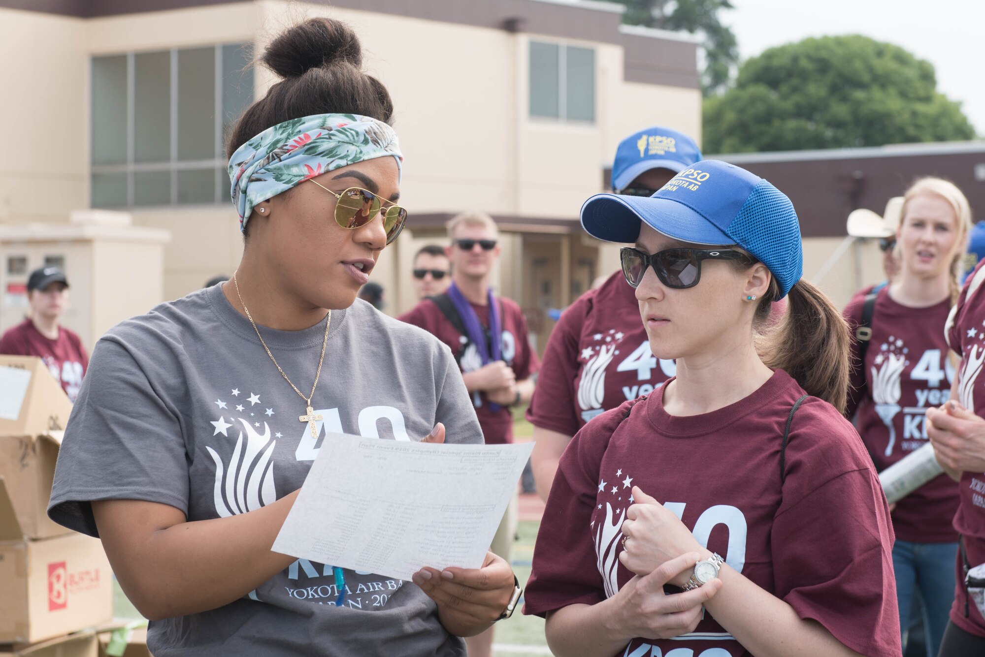 Master Sgt. Alexandria Riles, a member of the Kanto Plains Special Olympics committee, gives direction to a volunteer on the day of event at Yokota Air Base, Japan, June 1, 2019.