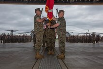 U.S. Marine Corps Brigadier Gen. Christopher A. McPhillips, left, commanding general of 1st Marine Aircraft Wing, and Maj. Gen. Thomas D. Weidley, outgoing commanding officer of 1st MAW, conduct the passing of the colors during 1st MAW’s change of command ceremony at Marine Corps Air Station Futenma, Okinawa, Japan, June 25, 2019. 1st MAW operates throughout the Indo-Pacific area of responsibility, supporting numerous operations, exercises and humanitarian aid missions. The change of command ceremony represents the transfer of responsibility, authority and accountability from the outgoing commanding general to the incoming commanding general. (U.S. Marine Corps photo by Lance Cpl. Ryan Persinger)