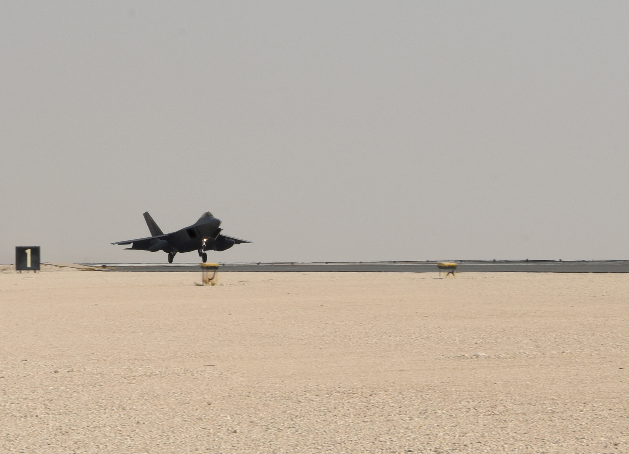 A photo of an F-22 landing.