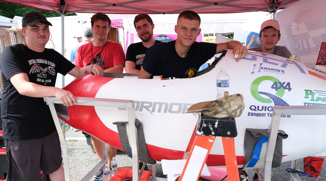 Dover Area High School team from Pennsylvania (from left) Caleb Helbert, Tyler Sengia, Braden Hilbert, Jakub Becker and Skyler Sinclair pose around their submarine, the Cormorant, at the 15th International Submarine Races at Naval Surface Warfare Center, Carderock Division in West Bethesda, Md., on June 25, 2019.