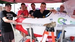 Dover Area High School team from Pennsylvania (from left) Caleb Helbert, Tyler Sengia, Braden Hilbert, Jakub Becker and Skyler Sinclair pose around their submarine, the Cormorant, at the 15th International Submarine Races at Naval Surface Warfare Center, Carderock Division in West Bethesda, Md., on June 25, 2019.