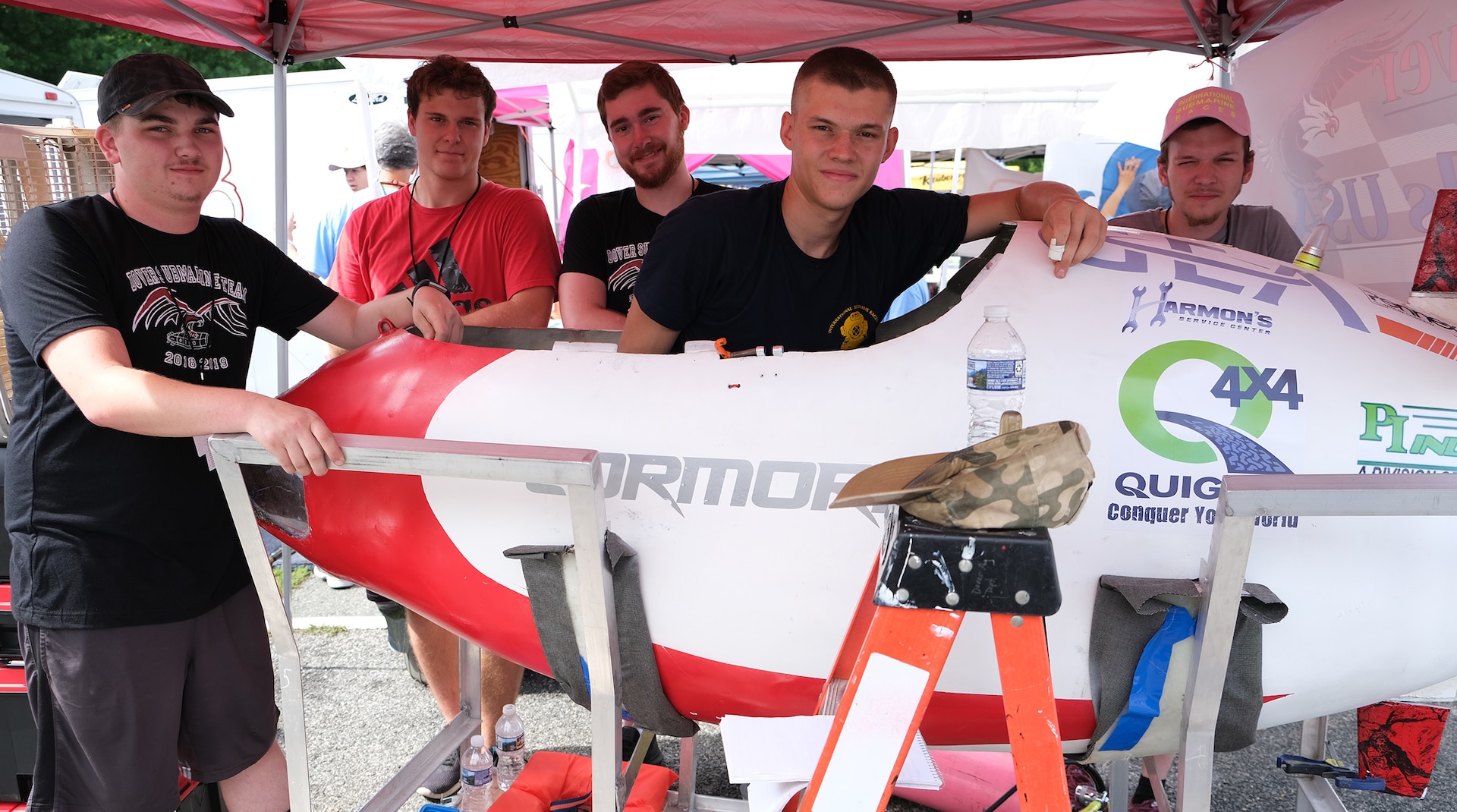 Dover Area High School team from Pennsylvania (from left) Caleb Helbert, Tyler Sengia, Braden Hilbert, Jakub Becker and Skyler Sinclair pose around their submarine, the Cormorant, at the 15th International Submarine Races at Naval Surface Warfare Center, Carderock Division in West Bethesda, Md., on June 25, 2019.