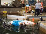 The Netherlands team members guide their human-powered submarine Wasub IX into the deep-water basin at Naval Surface Warfare Center, Carderock Division at the 15th International Human-Powered Submarine Races