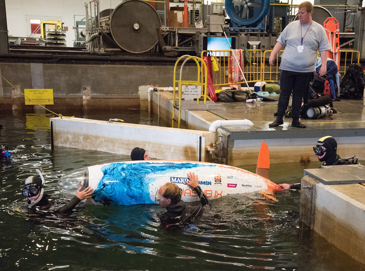 The Netherlands team members guide their human-powered submarine Wasub IX into the deep-water basin at Naval Surface Warfare Center, Carderock Division at the 15th International Human-Powered Submarine Races