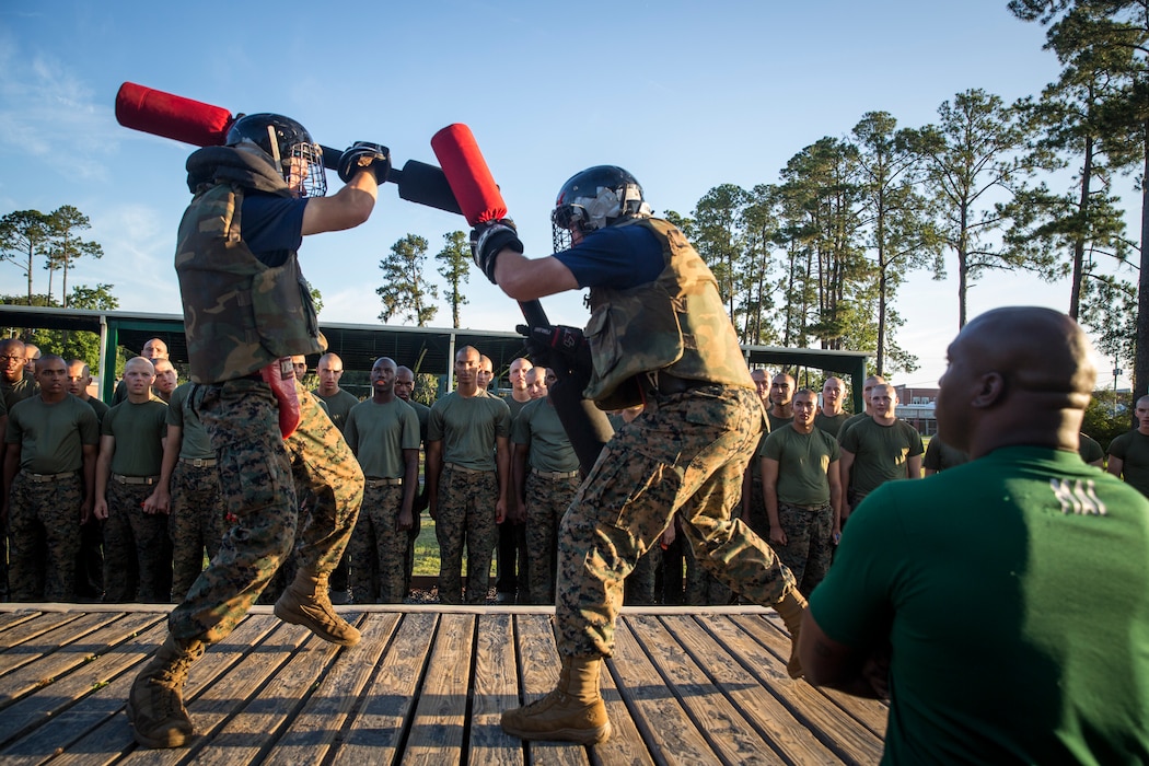 Recruits with Kilo Company, 3rd Recruit Training Battalion, engage pugil sticks at Marine Corps Recruit Depot Parris Island, S.C., June 21, 2019. Body sparring and pugil sticks help recruits apply the fundamentals of Marine Corps martial arts. (U.S. Marine Corps photo by Lance Cpl. Christopher McMurry)