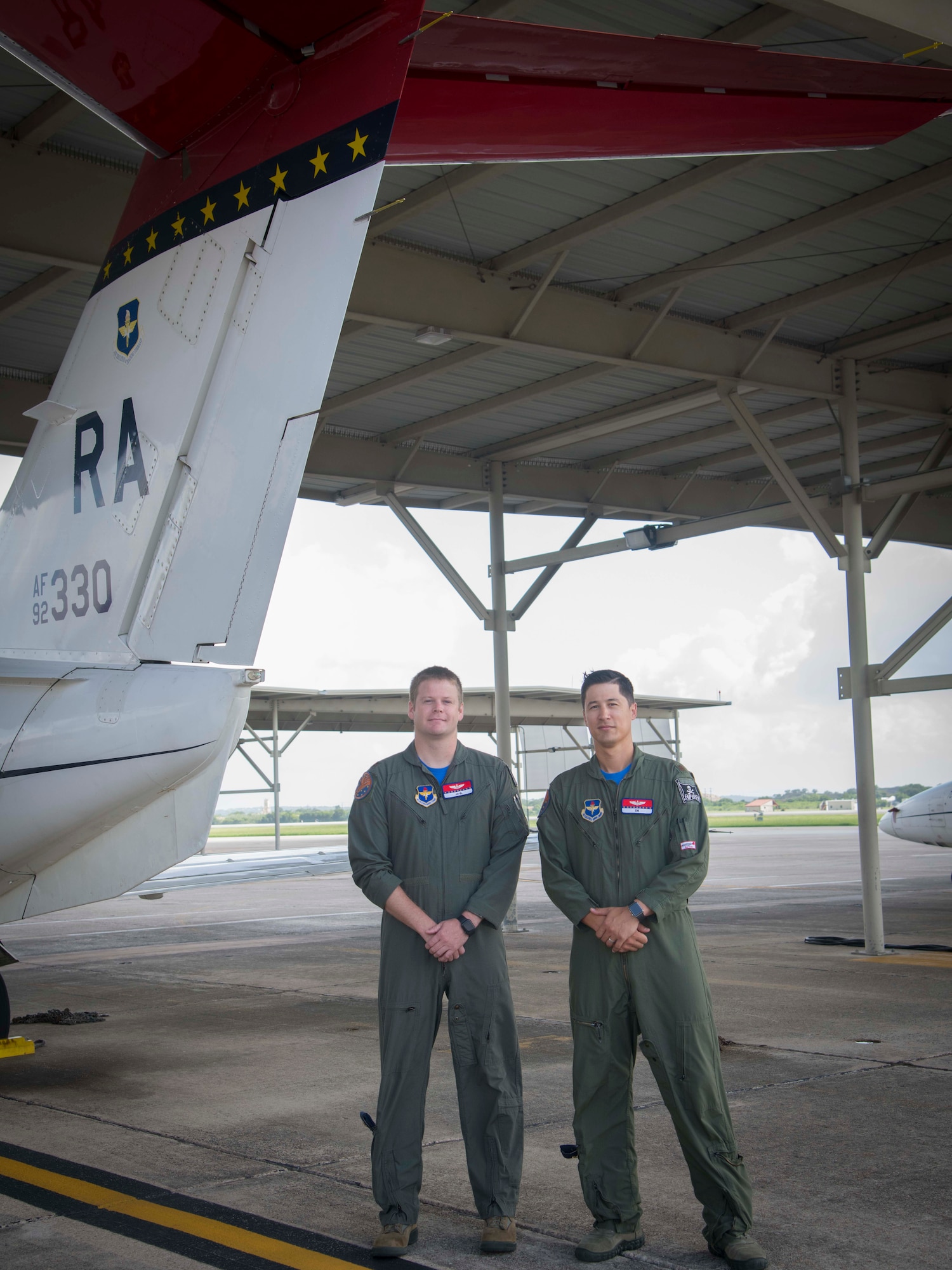 Maj. David Kim, 99th Flying Training Squadron Chief of Standardization and Evaluation and Maj. Joel Kliewer, 99th FTS pilot, pose in front of a T-1A Jayhawk. The T-1s sport a red stripe on the tail as a homage to their Tuskegee Airmen heritage. This resembles the red tails on the aircraft the original Tuskegee Airmen piloted as a way for their allies to spot them. (U.S. Air Force photo by: Airman 1st Class Shelby Pruitt)