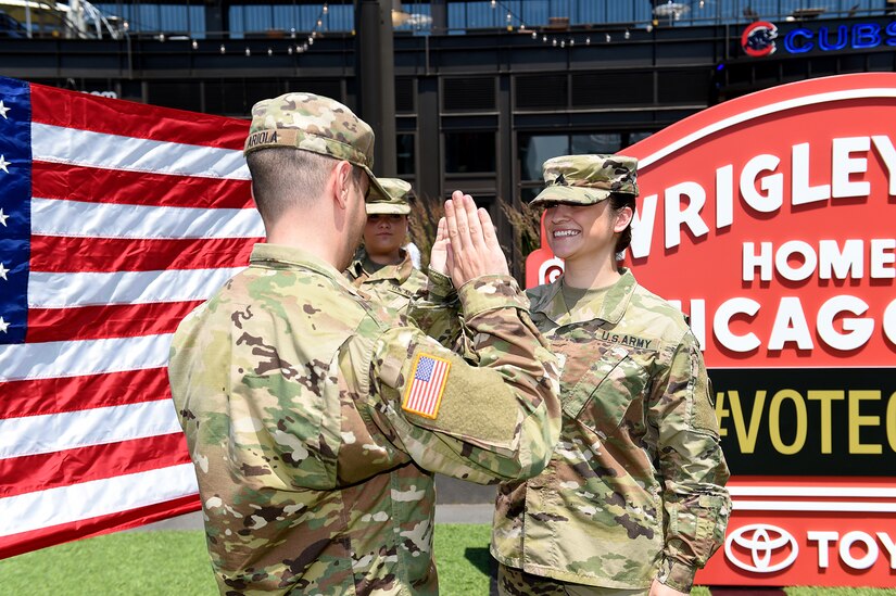 Sgt. Maribel Meraz, assigned to the 85th U.S. Army Reserve Support Command, headquartered in the northwest suburbs of Chicago, states the Oath of Enlistment at Gallagher Way, adjacent to the Chicago Cubs Wrigley Field, June 27, 2019, for a third six-years in the Army Reserve.