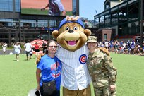 Sgt. Maribel Meraz, right, assigned to the 85th U.S. Army Reserve Support Command headquarters, pauses for a photo with her mother and Clark, Chicago Cubs mascot, at Gallagher Way, adjacent to the Chicago Cubs Wrigley Field, June 27, 2019, after reenlisting for a third six-years in the Army Reserve.
