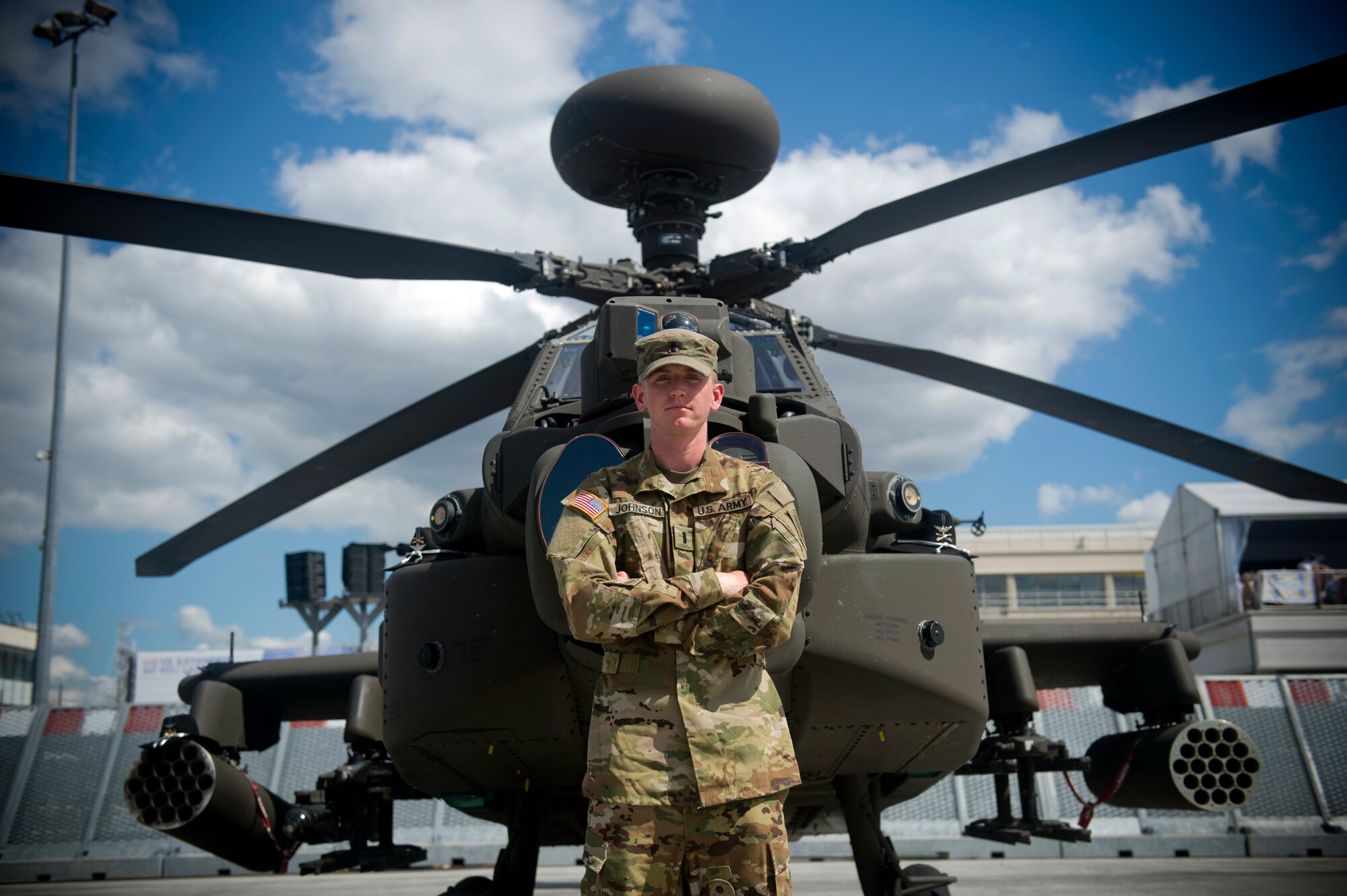 U.S. Army 1st Lt. Ryan Johnson, Bravo Troop, 1st Squadron, 6th Cavalry Regiment, 1st Combat Aviation Brigade, 1st Infantry Division, stationed at Fort Riley, Kan., poses for a photo in front of an AH-64E Apache helicopter from his unit at the Paris Air Show, June 21, 2019. Johnson was one of approximately 130 U.S. military aircrew and support personnel from bases in Europe and the U.S. who participated in the air show. (U.S. Air Force photo by Master Sgt. Eric Burks)