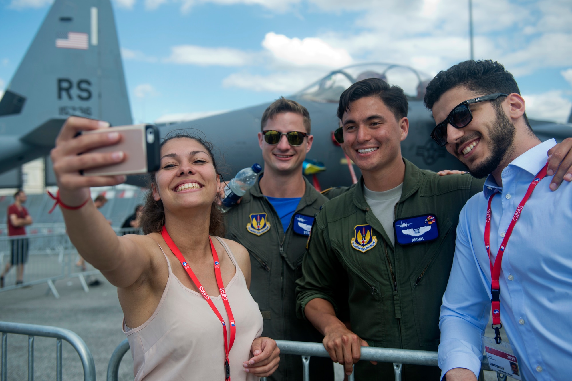 U.S. Air Force 1st Lt. Brandon "Animal" Shelley, a 492nd Fighter Squadron weapon systems officer from the 48th Fighter Wing at Royal Air Force Lakenheath, England, poses for a photo with visitors in front of an F-15E Strike Eagle from his squadron at the Paris Air Show, June 21, 2019. Shelley was one of approximately 130 U.S. military aircrew and support personnel from bases in Europe and the U.S. who attended the air show. (U.S. Air Force photo by Master Sgt. Eric Burks)