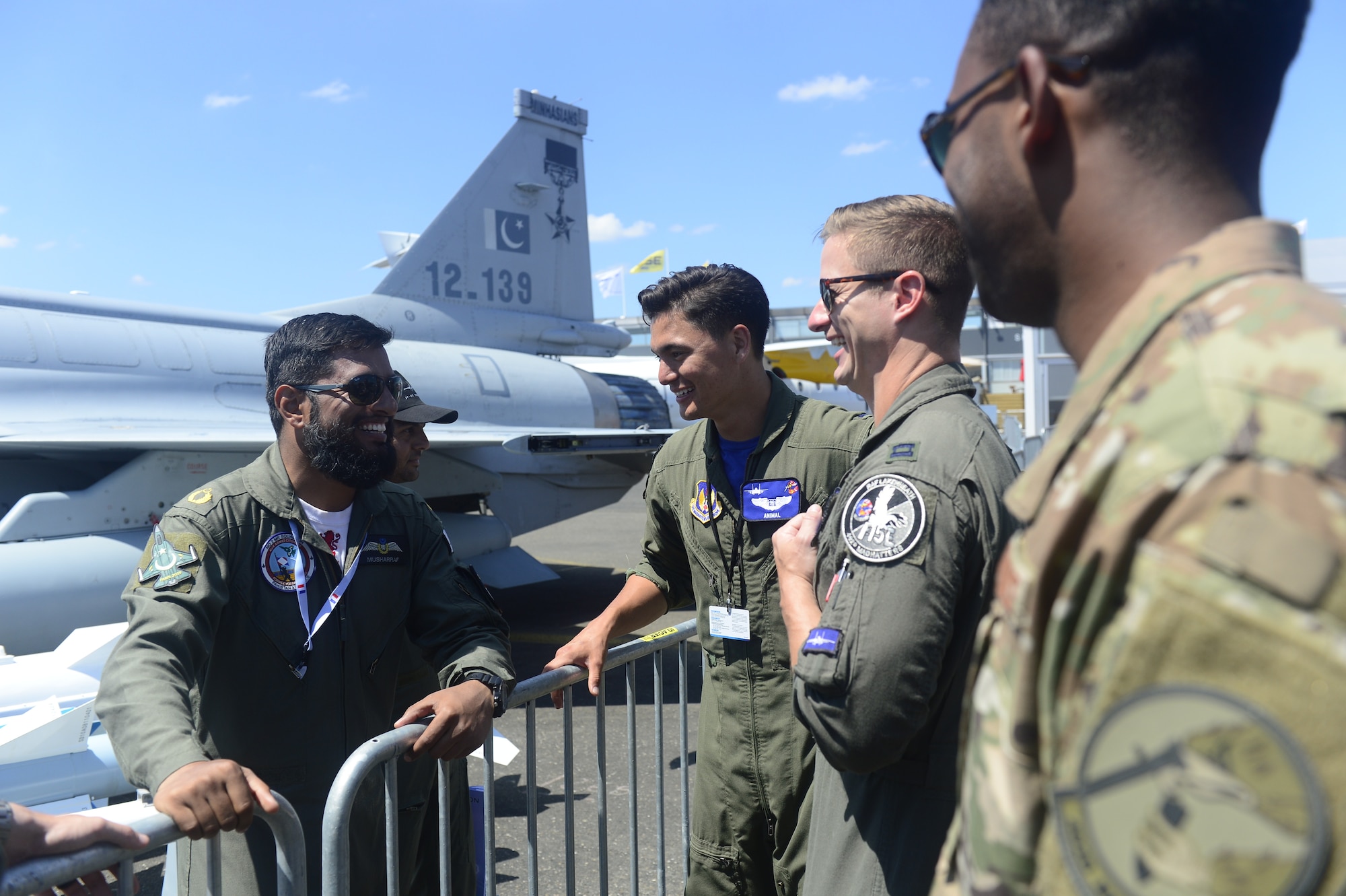 U.S. Air Force 1st Lt. Brandon "Animal" Shelley, a 492nd Fighter Squadron weapon systems officer from the 48th Fighter Wing at Royal Air Force Lakenheath, England, center, and other 48th FW Airmen engage with members of the Pakistan Air Force during the Paris Air Show at Le Bourget Airport, France, June 22, 2019. The air show provided a collaborative opportunity to share and strengthen U.S. and strategic international partnerships. (U.S. Air Force photo by Master Sgt. Eric Burks)