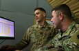 Capt.  Andrew Nowak, 594th Transportation Company commander, 129th Sustainment Battalion, 300th Sustainment Brigade, and 1st Lt. Fletcher Hopkins, executive officer, use the Operator Skill Tracker to evaluate Soldier’s skills for future operations at Camp Arifjan, Kuwait, May 13, 2019.