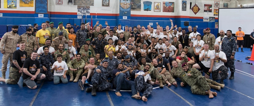 Kuwaiti armed forces pose for a group photo after a combatives tournament at Camp Arifjan, Kuwait, June 23, 2019. U.S. Army Central hosts events such as the combatives tournament to strengthen its relationship and build partner capacity with the Kuwaitis. USARCENT operates throughout the Middle East region and appreciates the generosity of the host nation’s willingness to maintain bilateral defense relationships.