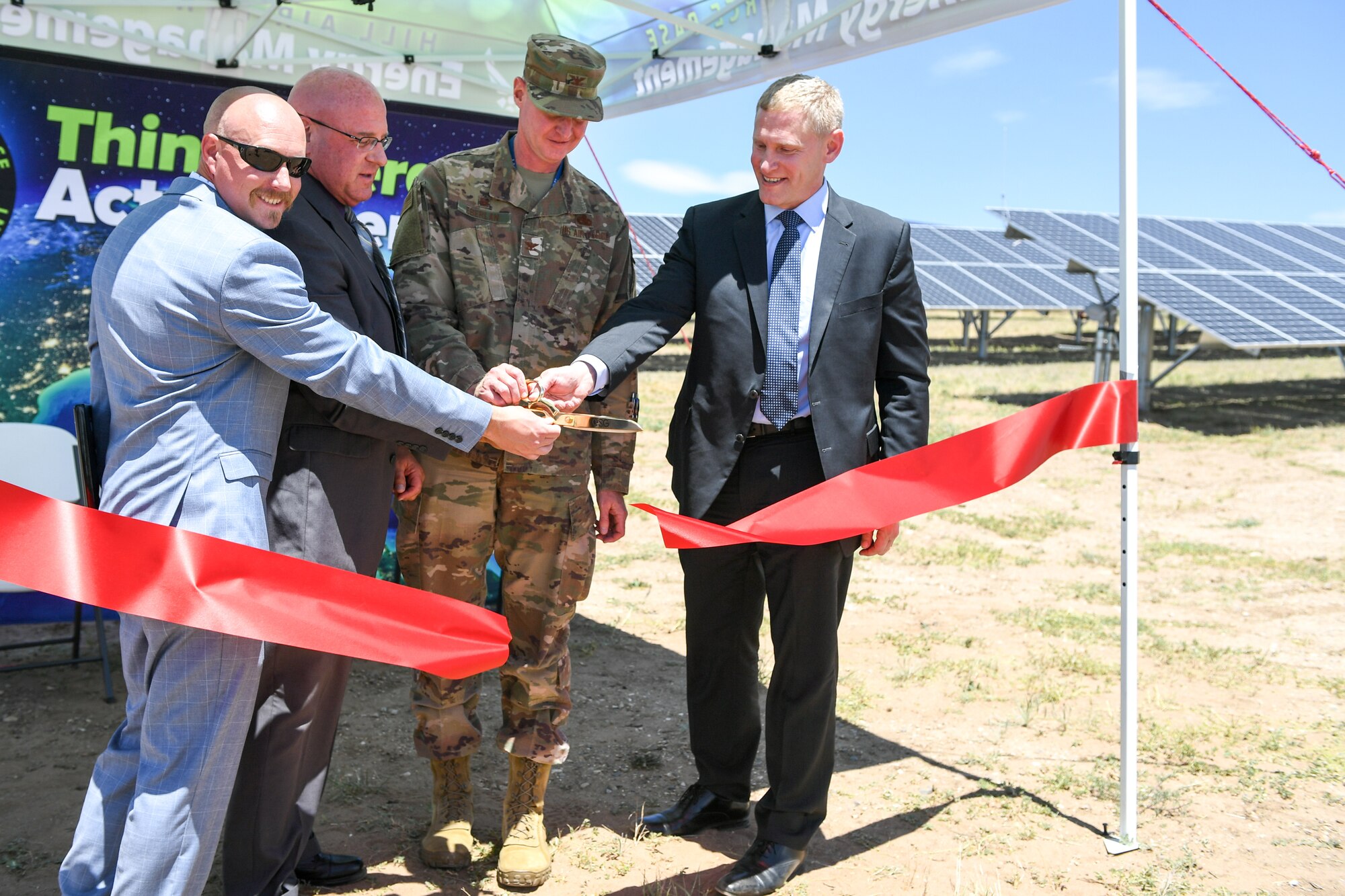 (Left to right) Nickolas King, base energy manager, Harry Briesmaster, 75th Civil Engineer Group director, Col. Jon Eberlan, 75th Air Base Wing commander, and Steven Spanbauer, senior vice president of the Federal Business Unit at Energy Systems Group, cut the ribbon June 27, 2019, during a ceremony at Hill Air Force Base, Utah, announcing the completion of the new ground-mounted solar array. The array was installed through an energy savings performance contract, which means there is no upfront cost to the government. (U.S. Air Force photo by Cynthia Griggs)