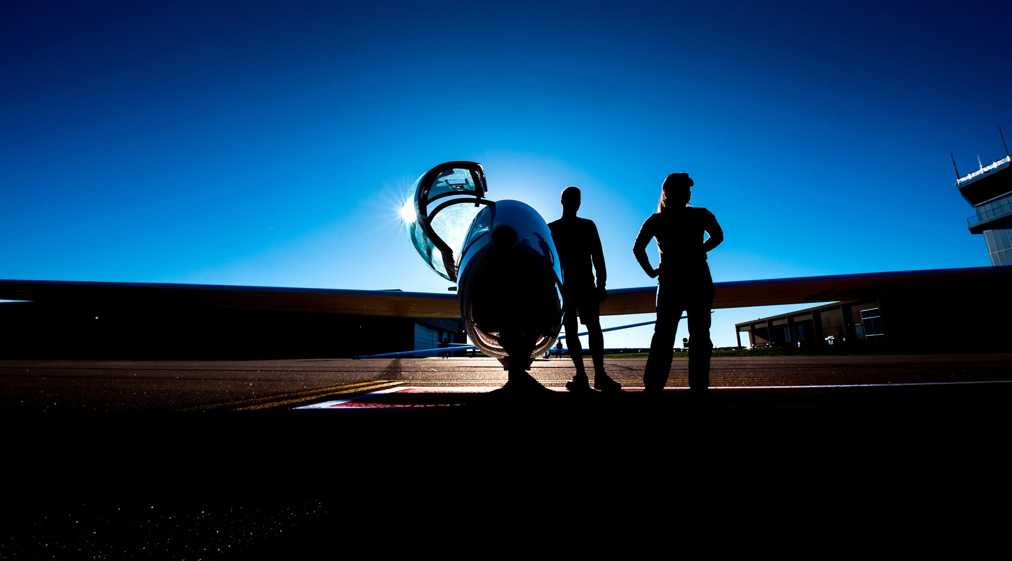 U.S. Air Force Academy cadets stand by for another plane to land