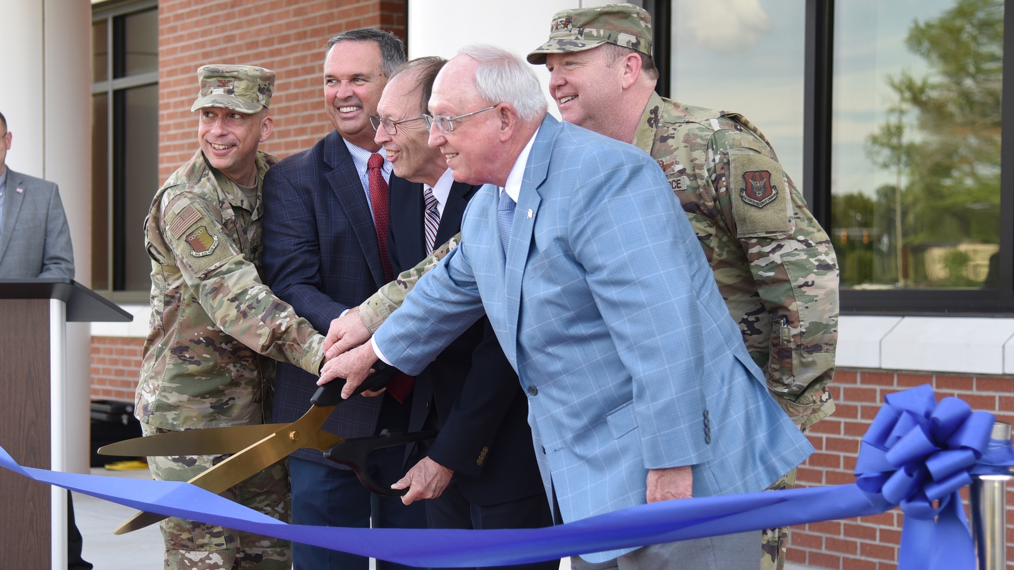 (From left to right) Col. Lyle Drew, 78th Air Base Wing commander, Warner Robins Mayor Randy Toms, retired Lt. Gen. Charles Stenner, Lt. Gen. Richard Scobee, commander of Air Force Reserve Command and Houston County Commissioners Chairman Tommy Stalnaker cut the ribbon during a ribbon cutting ceremony celebrating the completion of phase one of the consolidated mission complex June 25, on Robins Air Force Base in Georgia. Once completed the three-phase project will bring together 965 employees who are currently separated in nine different facilities. (U.S. Air Force photo by Misuzu Allen)