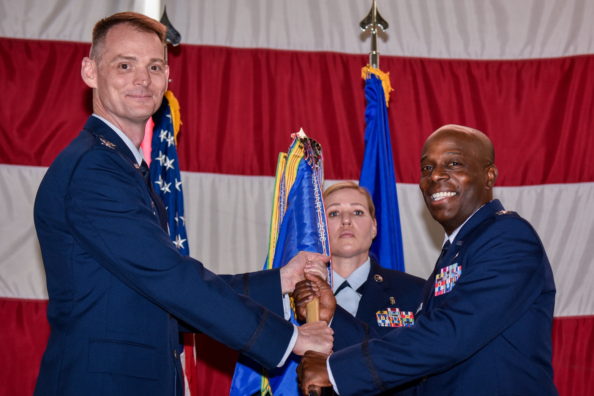 U.S. Air Force Col. Gregory Coleman (right), accepts the guidon and command of the 377th Medical Group from Col. David Miller, 377th Air Base Wing commander, in a change of command ceremony at Kirtland Air Force Base, N.M., June 27, 2019. As the 377th MDG commander, Coleman will continue where his predecessor left off and lead his Airmen in advancing the human weapons system, promoting optimal health and provide trusted care to Team Kirtland. (U.S. Air Force photo by Airman 1st Class Austin J. Prisbrey)