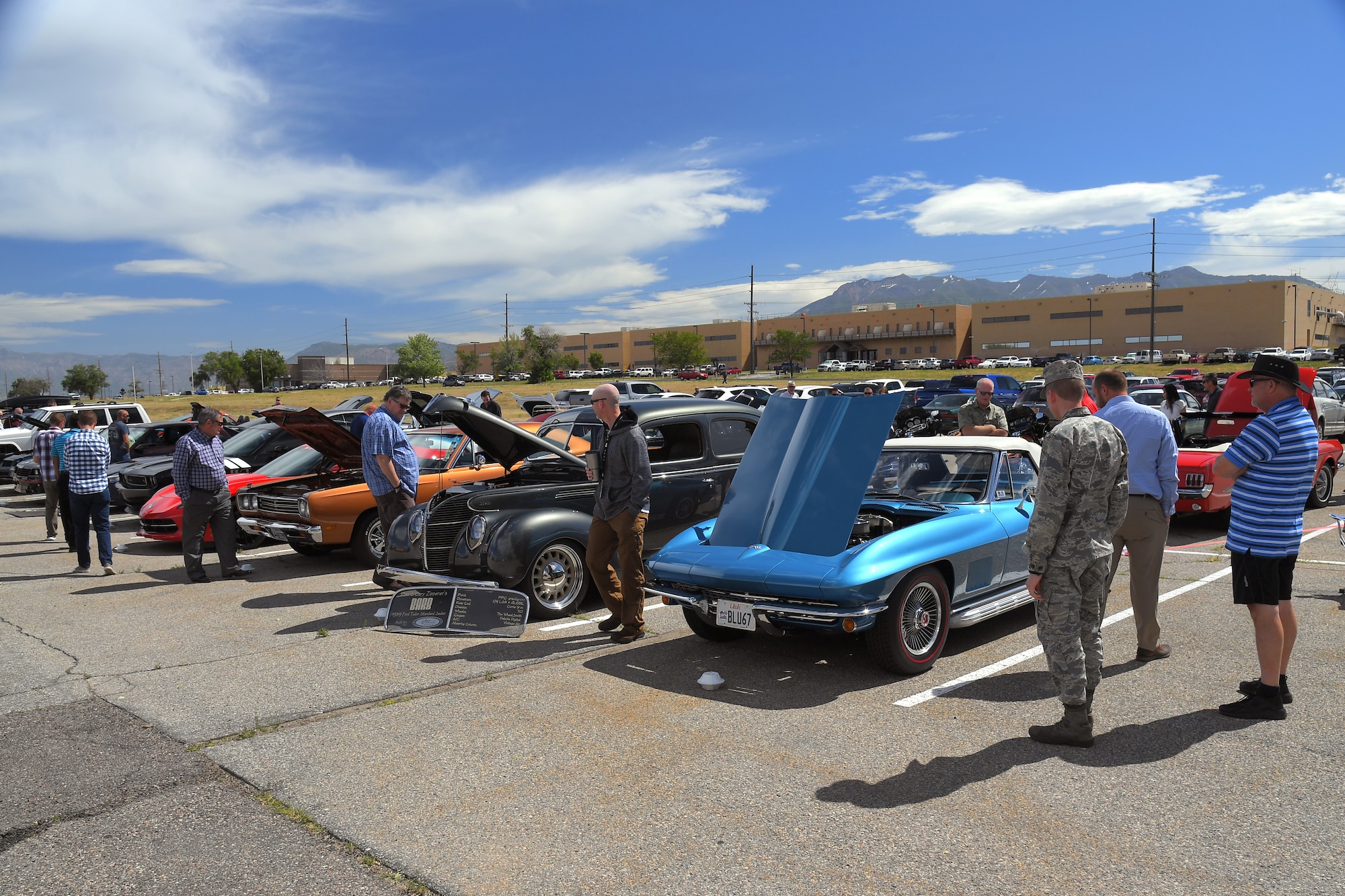 Guests enjoy a mix of modern and restored classics at a car show and barbecue hosted by the base’s Foreign Military Sales organization at Hill Air Force Base, Utah, June 27, 2019. The event was a first for the unit, and several program teams and employees displayed and shared details with visitors about their personally owned vehicles. (U.S. Air Force photo by Todd Cromar)
